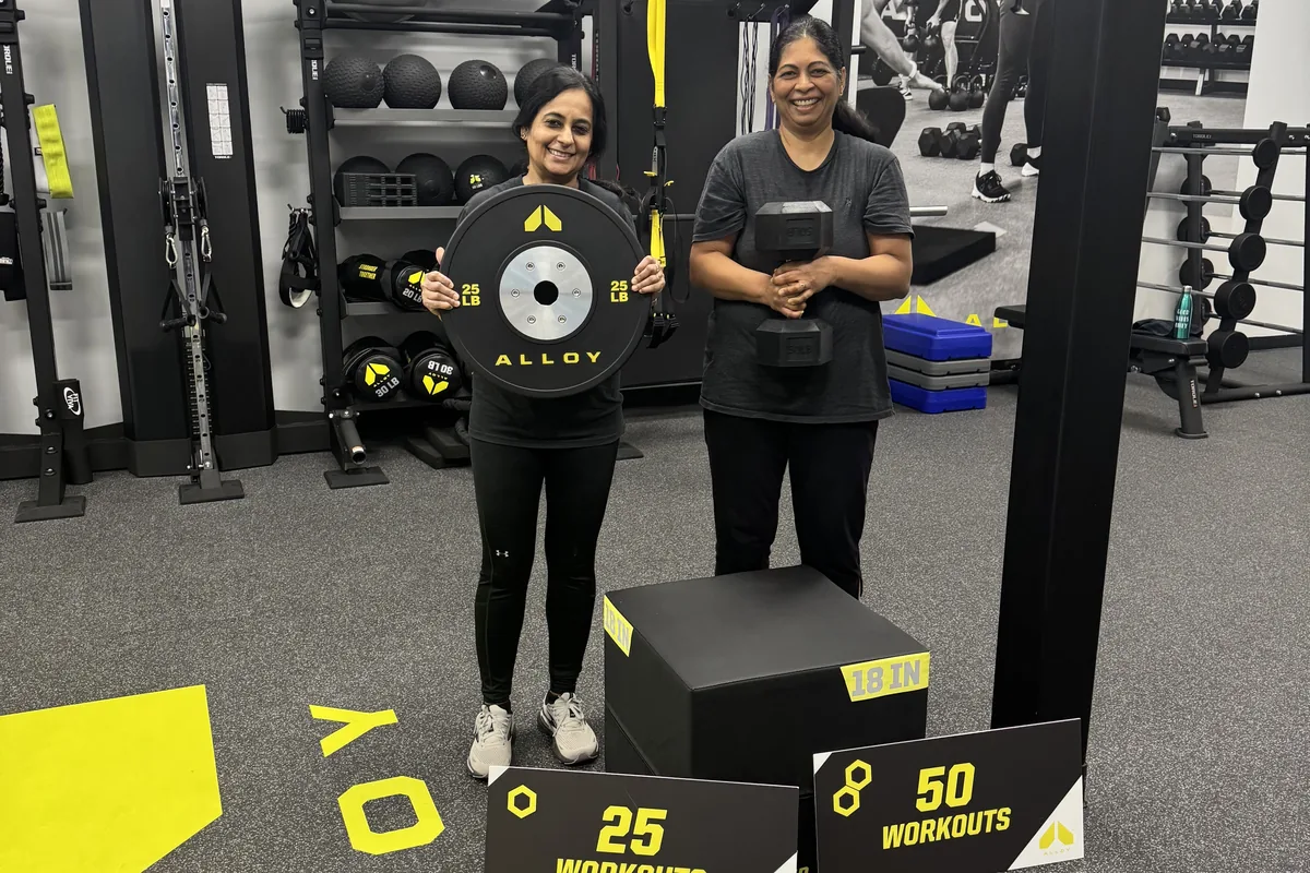 Alloy Cary members celebrating 25 and 50 workout milestones